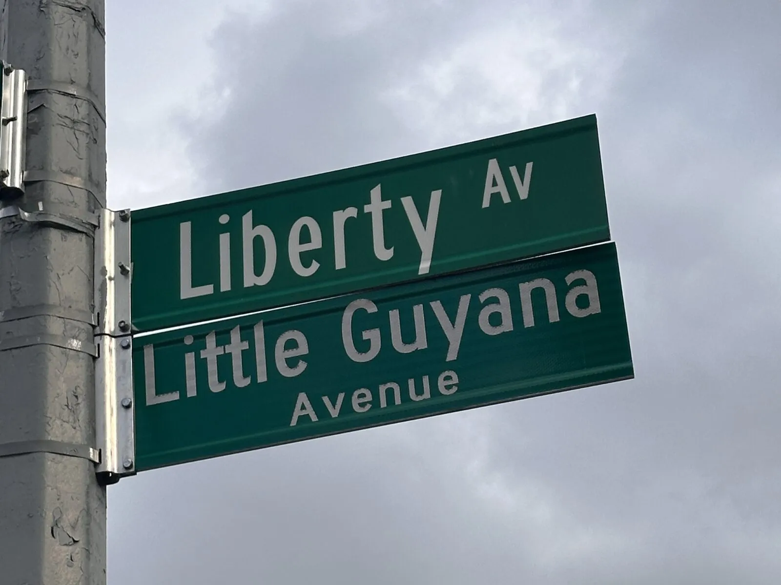 Liberty Avenue and Little Guyana Avenue street signs in Richmond Hill, Queens